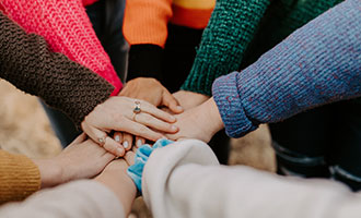 People in a hand huddle