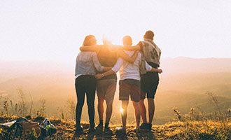 People Hugging at Mountain Top